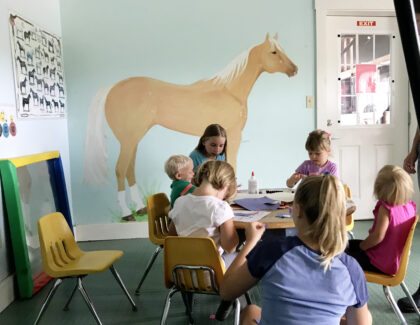children sitting around a table labeling horse parts
